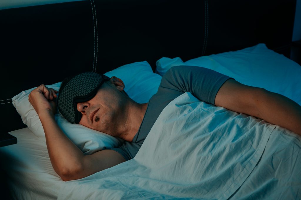 Man sleeping with an eye mask