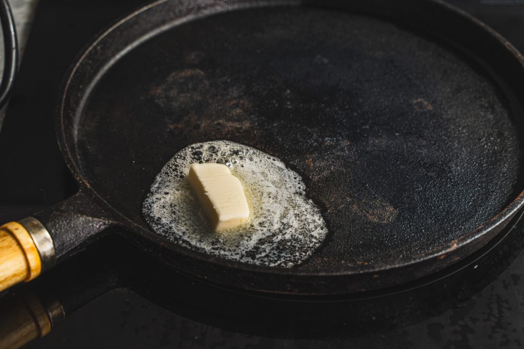Butter melting in a cast-iron pan