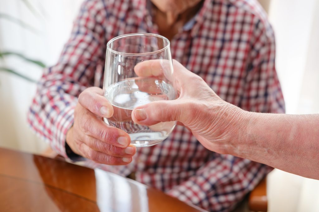 Someone accepting a glass of water 