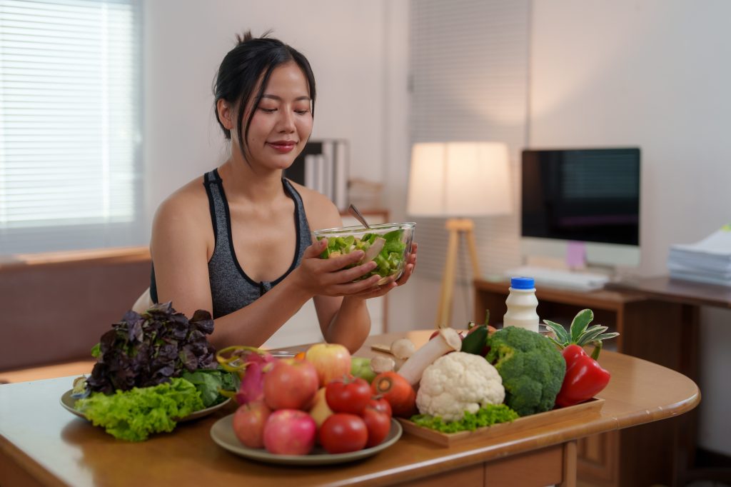 Woman holding a bowl of salad 