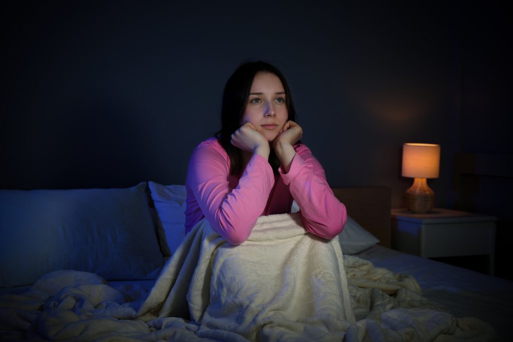Woman watching TV in bed