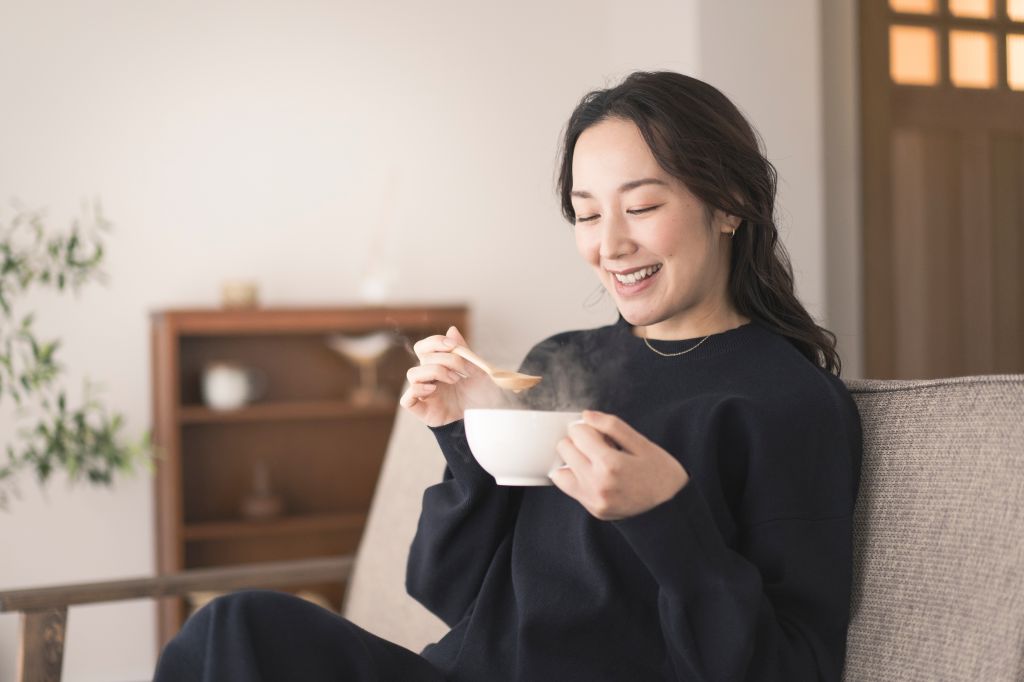 Woman drinking soup
