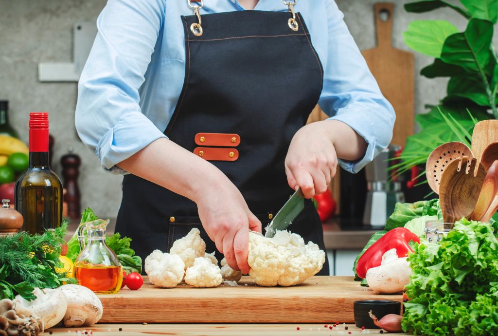 Woman chopping cauliflower