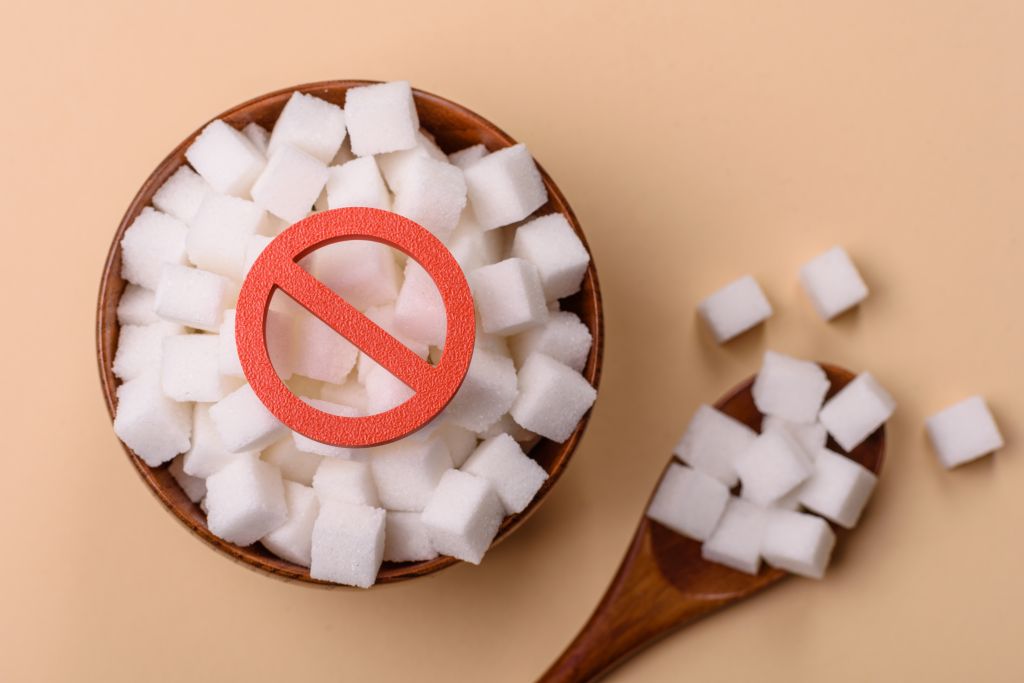 Sugar ban sign on sugar cubes