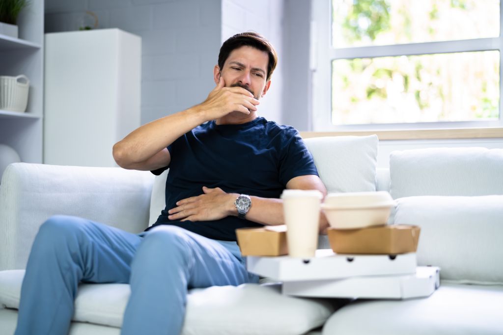Man with stomachache after eating fast food