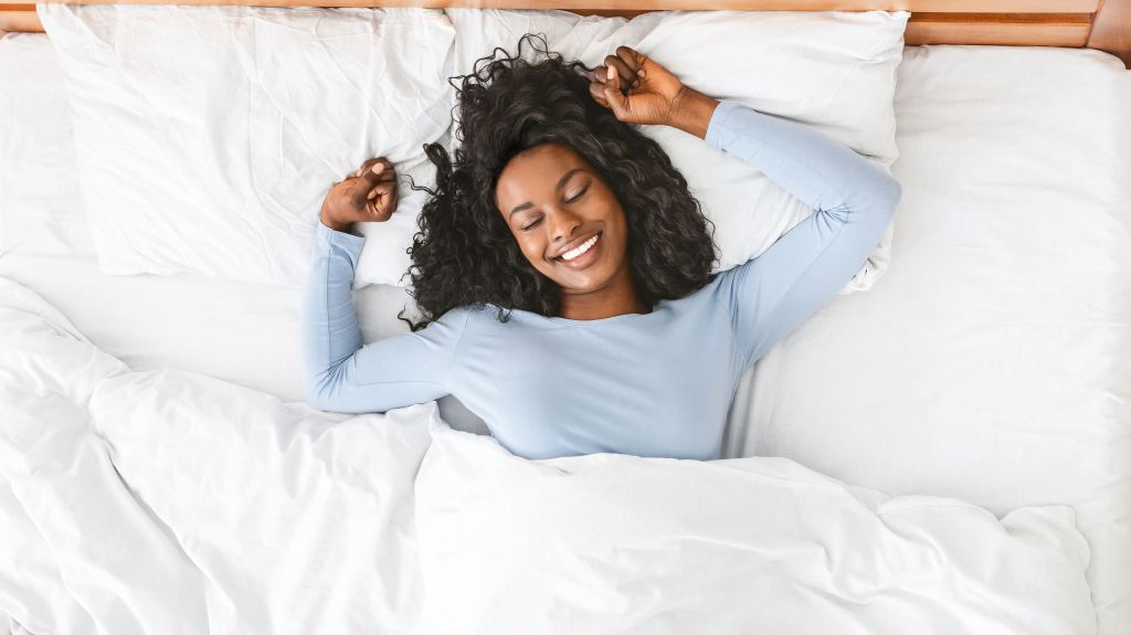 Woman stretching in bed