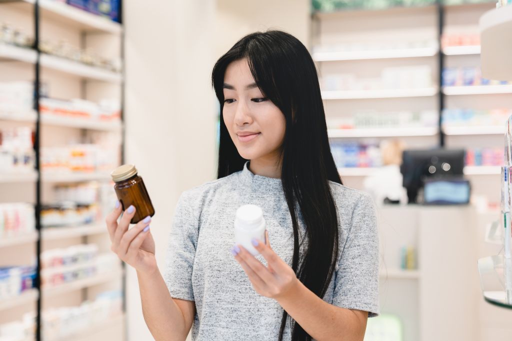Woman looking at two supplements